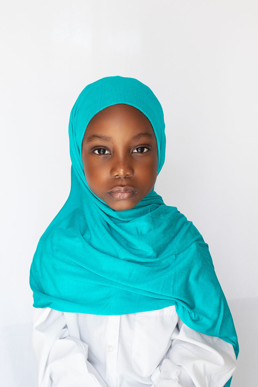 a girl is wearing blue hijab
